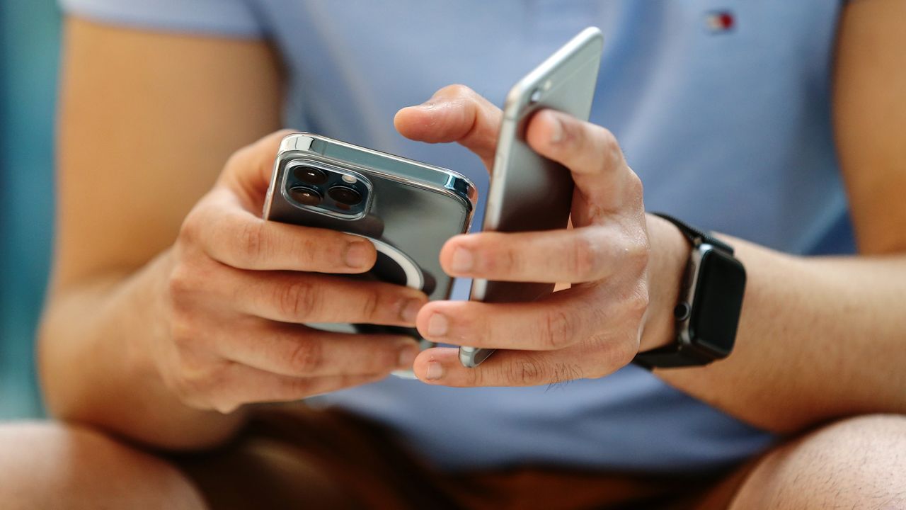 A customer tries out an iPhone 12 Pro Max at the Apple flagship store during a product launch event in Sydney, Australia, on November 13, 2020.